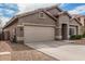 Charming single-story home featuring a two-car garage and a well-maintained front yard at 15829 W Boca Raton Rd, Surprise, AZ 85379