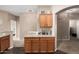 Cozy coffee bar area in kitchen with granite countertops, wood cabinets, and access to other living spaces at 15829 W Boca Raton Rd, Surprise, AZ 85379