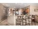 Kitchen with breakfast bar, granite countertops, decorative chairs, and stainless steel appliances at 15829 W Boca Raton Rd, Surprise, AZ 85379