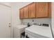 Laundry room featuring a washer and dryer, with storage cabinets at 15829 W Boca Raton Rd, Surprise, AZ 85379