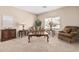 Inviting living room featuring neutral walls and carpet, and comfortable furnishings at 15829 W Boca Raton Rd, Surprise, AZ 85379