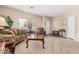 Inviting living room featuring neutral walls and carpet, and comfortable furnishings at 15829 W Boca Raton Rd, Surprise, AZ 85379