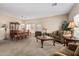 Inviting living room and dining area featuring neutral walls and carpet, and classic furnishings at 15829 W Boca Raton Rd, Surprise, AZ 85379