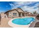 Backyard pool with desert landscaping and blue skies above at 15829 W Boca Raton Rd, Surprise, AZ 85379