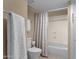 Bright bathroom features a toilet, towel rack, and a shower with a striped curtain at 16739 E El Lago Blvd # 103, Fountain Hills, AZ 85268