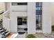 Inviting condo front entrance with stylish black door and well-kept landscaping at 16739 E El Lago Blvd # 103, Fountain Hills, AZ 85268