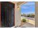 Close-up of the front door showing the secure gate and view from the doorway at 16739 E El Lago Blvd # 103, Fountain Hills, AZ 85268