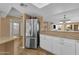 Open kitchen with granite counters, white cabinets, and stainless steel refrigerator at 16739 E El Lago Blvd # 103, Fountain Hills, AZ 85268