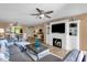 Open-concept living room featuring a fireplace, ceiling fan, and seamless transition to the dining area at 16739 E El Lago Blvd # 103, Fountain Hills, AZ 85268