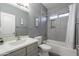 Stylish bathroom with gray tile, tub, shower, and white vanity at 17216 E Salida Dr # B, Fountain Hills, AZ 85268