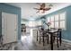 Cozy dining area with a wood table, chairs, ceiling fan, and plantation shutters for natural light at 17216 E Salida Dr # B, Fountain Hills, AZ 85268