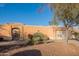View of single-story home with arched entrance, desert landscaping, and private two-car garage at 17216 E Salida Dr # B, Fountain Hills, AZ 85268