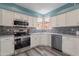 Modern kitchen featuring white cabinets, stainless steel appliances, and elegant gray backsplash tiles at 17216 E Salida Dr # B, Fountain Hills, AZ 85268