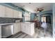 Well-lit kitchen with white cabinets, stainless steel appliances, open layout, and view to the dining area at 17216 E Salida Dr # B, Fountain Hills, AZ 85268