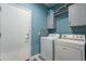 Convenient laundry room with washer and dryer, gray cabinets and an exterior door at 17216 E Salida Dr # B, Fountain Hills, AZ 85268