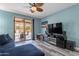 Bright living room with gray luxury vinyl plank flooring, comfy blue sofa, and a view to the patio at 17216 E Salida Dr # B, Fountain Hills, AZ 85268