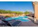 Inviting backyard with a refreshing pool, relaxing lounge chairs, mature palms, and lush greenery at 17216 E Salida Dr # B, Fountain Hills, AZ 85268