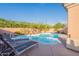 Inviting backyard pool and spa area with lush landscaping, lounge chairs, and clear blue skies at 17216 E Salida Dr # B, Fountain Hills, AZ 85268