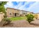Serene backyard featuring lush green grass and desert landscaping, complemented by the two-story home at 17507 N Costa Brava Ave, Maricopa, AZ 85139