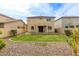 Charming backyard featuring green grass surrounded by low-maintenance desert landscaping and block wall fencing at 17507 N Costa Brava Ave, Maricopa, AZ 85139