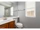 Bright bathroom with a white sink, toilet, vanity, and a mirror above the sink at 17507 N Costa Brava Ave, Maricopa, AZ 85139