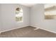 Bedroom with light gray walls and neutral carpet with natural light at 17507 N Costa Brava Ave, Maricopa, AZ 85139