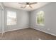 Bedroom with a ceiling fan, neutral carpet, and natural light at 17507 N Costa Brava Ave, Maricopa, AZ 85139