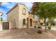 Exterior shot of home with arched entry, desert landscaping, and a two-car garage at 17507 N Costa Brava Ave, Maricopa, AZ 85139
