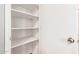A pantry with white shelving and ample storage space at 17507 N Costa Brava Ave, Maricopa, AZ 85139