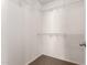 Walk-in closet featuring built-in shelves for easy organization at 17507 N Costa Brava Ave, Maricopa, AZ 85139