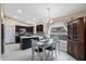 Dining area features modern lighting and is adjacent to the kitchen, complete with a window view at 1770 W Derringer Way, Chandler, AZ 85286