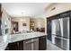 Gourmet kitchen featuring granite countertops, stainless steel appliances, and seamless flow to dining area at 1770 W Derringer Way, Chandler, AZ 85286