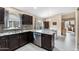 Beautiful kitchen featuring granite countertops, dark wood cabinets, and stainless steel appliances at 1770 W Derringer Way, Chandler, AZ 85286