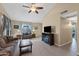 Inviting living room featuring wood floors, neutral paint, ceiling fan and comfortable seating at 1770 W Derringer Way, Chandler, AZ 85286