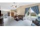 Bright and airy living room with wood floors, a ceiling fan, and glass patio doors that lead to the backyard at 1770 W Derringer Way, Chandler, AZ 85286