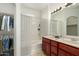 Well-lit bathroom features a double sink vanity, shower-tub combo, and closet space at 18250 N Cave Creek Rd # 147, Phoenix, AZ 85032