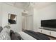A well-lit bedroom showcases modern design, a sleek TV, and convenient closet access at 18250 N Cave Creek Rd # 147, Phoenix, AZ 85032