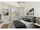 This is a cozy bedroom featuring a ceiling fan, stylish decor, and a bright window view at 18250 N Cave Creek Rd # 147, Phoenix, AZ 85032
