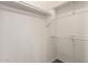 A bright, empty walk-in closet offers ample storage with multiple rods and shelving at 18250 N Cave Creek Rd # 147, Phoenix, AZ 85032