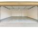 A spacious two-car garage with an open door and concrete flooring offers ample parking at 18250 N Cave Creek Rd # 147, Phoenix, AZ 85032