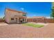 Spacious backyard features synthetic grass, sport court, patio, and block wall for privacy at 18318 W Pueblo Ave, Goodyear, AZ 85338