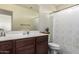 Charming bathroom featuring a vanity with great counterspace and a shower/tub with a decorative curtain at 18318 W Pueblo Ave, Goodyear, AZ 85338