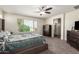 Relaxing bedroom featuring a large window for natural light and plush carpet at 18318 W Pueblo Ave, Goodyear, AZ 85338