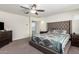 Comfortable bedroom with carpet, a large bed, and convenient side tables at 18318 W Pueblo Ave, Goodyear, AZ 85338