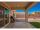 Relaxing covered patio with ceiling fan, BBQ and adjacent to a well manicured backyard at 18318 W Pueblo Ave, Goodyear, AZ 85338