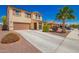 Charming two-story home with a desert landscaped front yard, a concrete driveway, and inviting curb appeal at 18318 W Pueblo Ave, Goodyear, AZ 85338