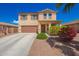 Inviting two-story home featuring a desert landscape, complemented by a neat lawn, and a two-car garage at 18318 W Pueblo Ave, Goodyear, AZ 85338
