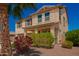 Charming two-story home with desert landscaping and a palm tree, situated on a well-maintained street at 18318 W Pueblo Ave, Goodyear, AZ 85338