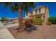 Charming two-story home with desert landscaping and a palm tree, situated on a well-maintained street at 18318 W Pueblo Ave, Goodyear, AZ 85338