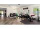 Spacious home gym featuring a workout area, a desk and chair and wood-look tile flooring at 18318 W Pueblo Ave, Goodyear, AZ 85338